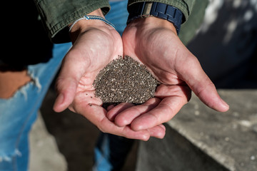 young woman with chia seeds in her hands showing the current trend towards a healthy and balanced organic diet
