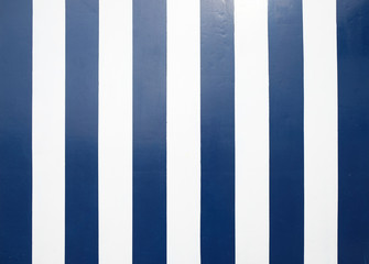 Empty surface with broad diagonal dark blue and white stripes.
