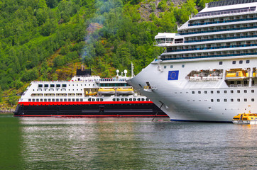 Small Hurtigruten post ship or cruise ship liner MS Trollfjord meets huge Costa Cruises cruiseship...