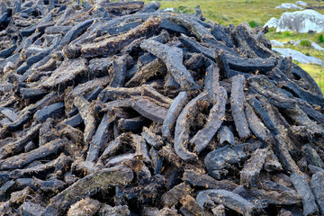 A pile of strips of peat cut in the typical Irish bog.