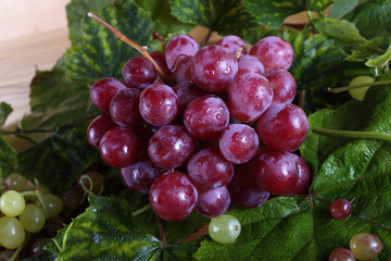 Grape and leaves on table