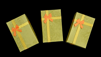 golden rectangular gift boxes on dark background