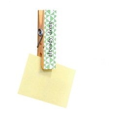 Yellow stick note paper pinned on peg.