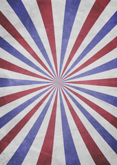 A patriotic red, white and blue sunburst effect grunge textured background with aged paper effect