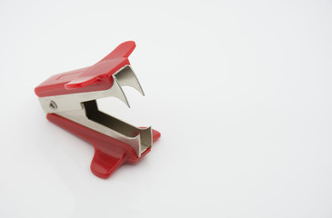 The staple remover, a stapler used to extract the staples that hold the sheets of paper.