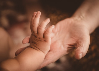  A small hand pats the old woman's palm