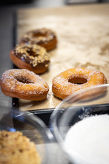 Doughnuts chocolate and chopped hazelnuts with sugar