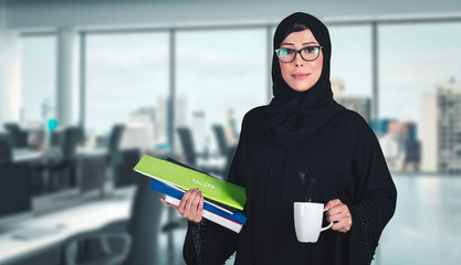 Office Woman - Arab girl on Abaya Hijab black dress in Middle East. Beautiful Arabic Emirati lady at inside a business boardroom.