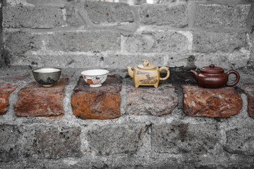 Chinese pottery. Tea ware for traditional chinese tea ceremony. Stone gray wall on the background.