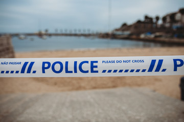 Police sign at closed beach