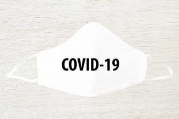 Cloth white mask isolated on modern white wooden background - for prevent dust (PM 2.5), disease (Coronavirus or COVID-19).
