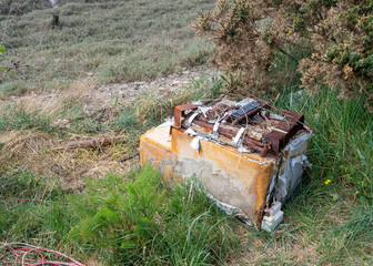 Decomposing old fridge, dumped, rusted in the environment. Washed up by river.