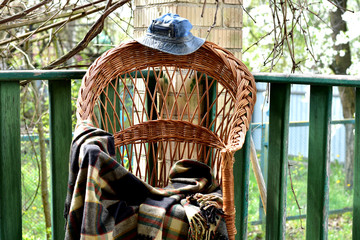 On the veranda is a chair on which a checkered blanket is left.