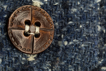 macro or close-up photo of the vintage shirt button. the focus on the button. this is textile, texture, or tissue concepts. It could be used as also background, wallpaper, abstract concept.