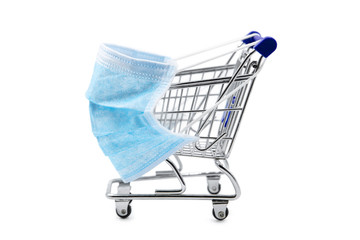 Surgical face mask on little shopping trolley or cart, mandatory masking on supermarkets,...