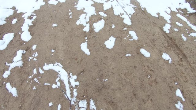 Snow falling on a sandy