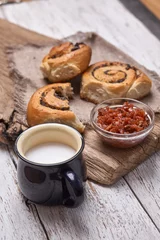 Fotobehang Variety of homemade puff pastry buns cinnamon served with milk cup, jam, butter as breakfast over white plank wooden background. Flat lay, space © Igor Syrbu