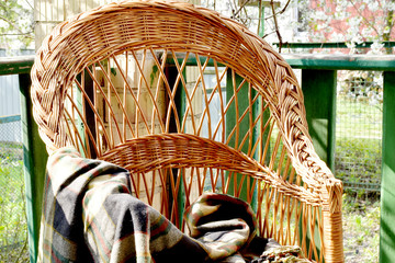 On the veranda is a chair on which a checkered blanket is left.