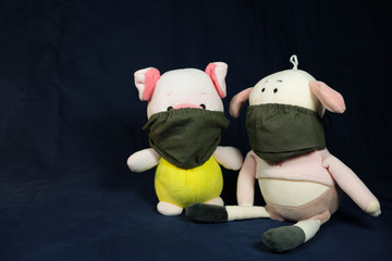 Pigs puppets with a protection mask on the mouth. Coronavirus style.