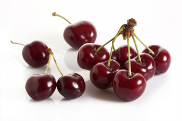 Cherry branch of sweet and fresh cherries on a white background.