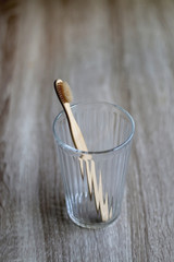 Bamboo toothbrush in a glass. Selective focus.