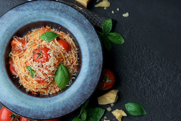 Spaghetti with tomato sauce on a dark background