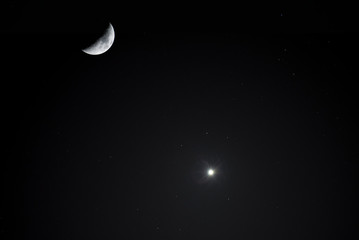 Obraz na płótnie Canvas Astronomical photography. Close-up moon and Venus planet on the dark sky. Night photography.
