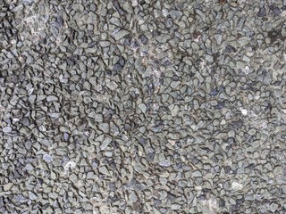 Texture of cemented small gray (grey) stones (gravel) for background or backdrop
