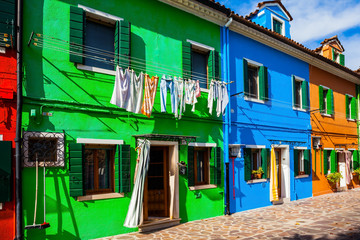 Colorful linens are dried on the balconies