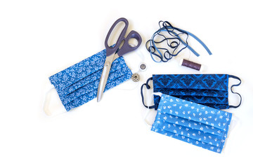 Homemade cloth face mask from cotton and sewing utensils, protection against droplet infection...