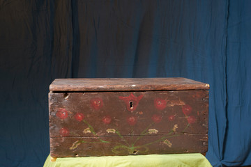 Hand painted folk art wooden chest with red flowers from the 20th century