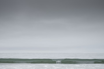 Storm over ocean with glassy wave