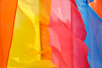 Bright multicolored vertical flags on flagpoles