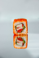 Sushi roll on a mirror table with reflection - 344613895