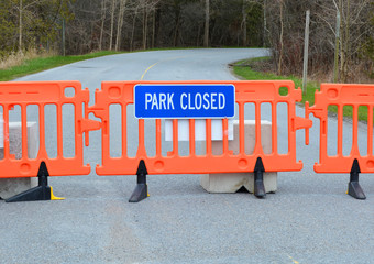 Barricade and sign at the entrance to provincial and national park to indicate closure.