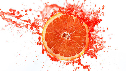 Freeze motion of sliced grapefruit with splashing juice isolated on white background