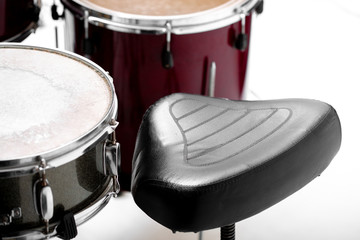 drum set on white background. Set of musical instruments and black chair