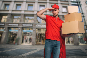 Red courier acts like a powerful superhero. Concept of success and guarantee on shipment.