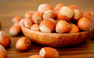 Filtered image of Hazelnuts in a bowl on rustic background