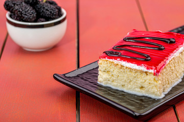 home made tiramisu cake with raspberry and blackberry on it