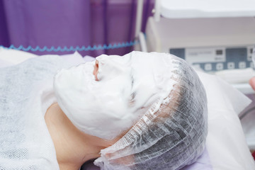 A cosmetologist does an ultrasonic cleaning of the skin of the face.