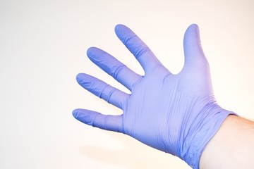 Purple glove on hand coronavirus