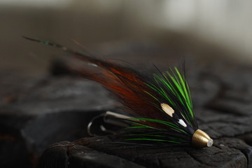 Traditionally dressed salmon fly shot against a wood background