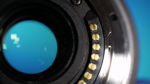 Close-up of bayonet mount camera lens with contacts. Concept of professional service for the repair of photographic equipment or filmmaker