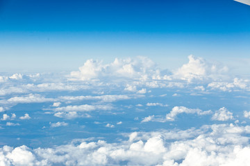 Fototapeta na wymiar Clouds top view of the airplane. Heavenly landscape.