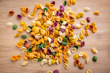 Colored fresh pasta orecchiette made with vegetables and spices. Food of Puglia, Italy