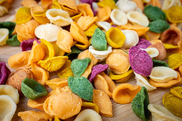 Close up of colored fresh pasta orecchiette made with vegetables and spices. Food of Puglia, Italy