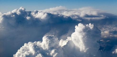 Naklejka na ściany i meble Clouds top view of the airplane. Heavenly landscape.