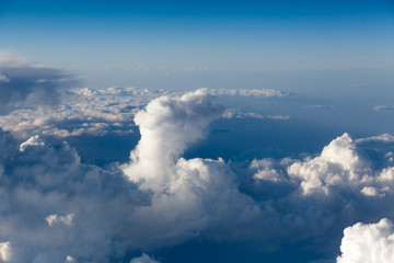 Fototapeta na wymiar Clouds top view of the airplane. Heavenly landscape.