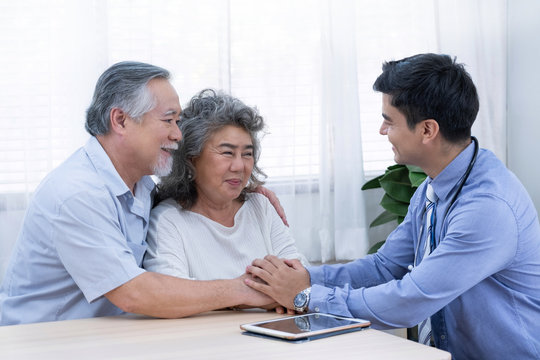 The doctor encourage old man and woman about their health during visit home for check-up elder people at home.
